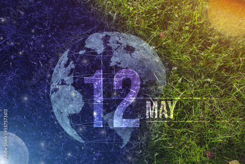 May 12nd. Day 12 of month, Calendar date. Day to night background concept. Scene with globe the green grass with sun, stars, moon and calendar date. Spring month, day of the year concept.