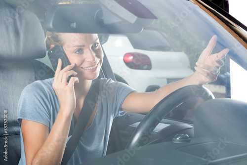 Obraz na plátne happy woman with phone in car