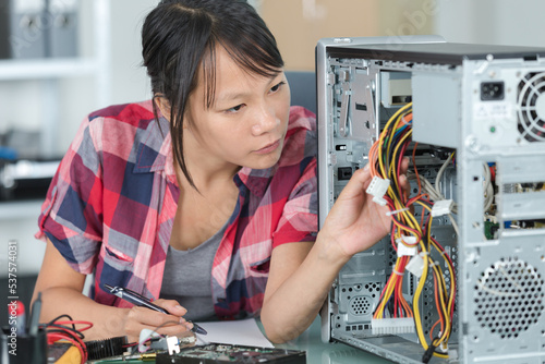 female engineer fixing a broken processor