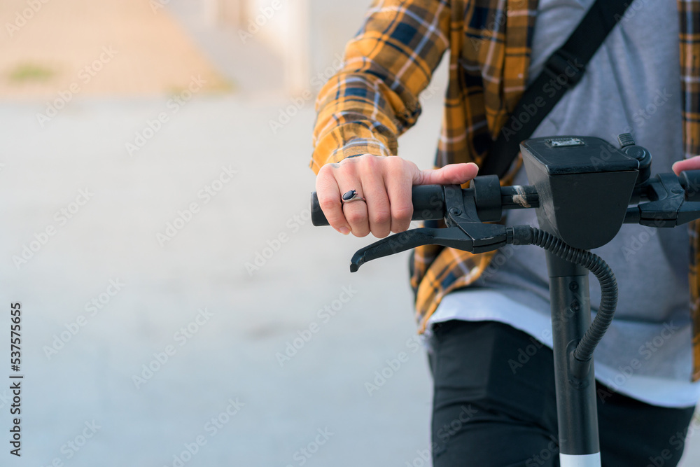 Close-up of a man riding an electric scooter on a park Close-up of a man riding an electric scooter on a park