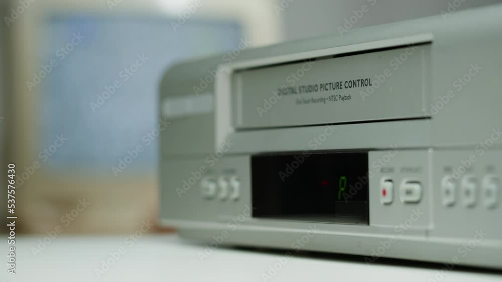 Old video recorder close-up, VHS. Retro player, video cassette broadcasting, audio tape. Watching vintage television. Old video recorder close-up, VHS. Retro player, video cassette broadcasting, audio tape. Watching vintage television.