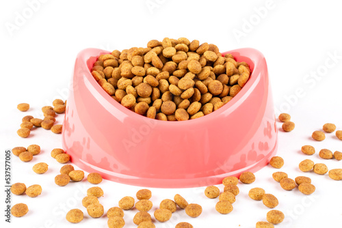 Pink bowl with dry food for a cat (dog) on a white isolated background. Template, design. Balanced pet food.