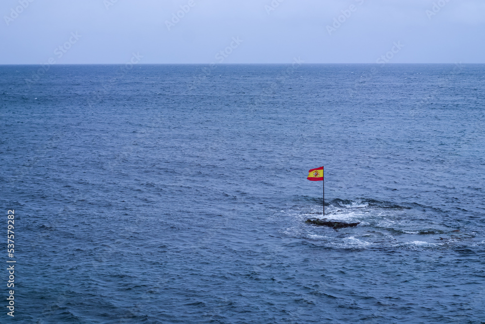 Spanish flag standing in the middle of the Atlantic Ocean, Gran Canaria