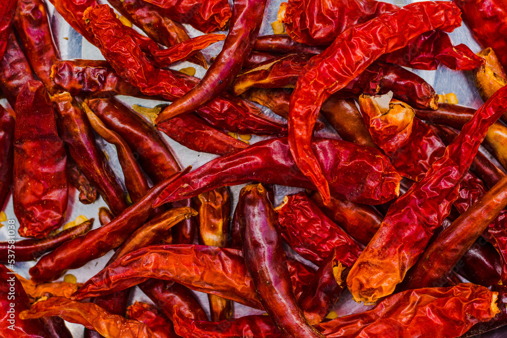 Red hot dried chili pepper on white background. Top view closeup. Red hot dried chili pepper on white background. Top view closeup.