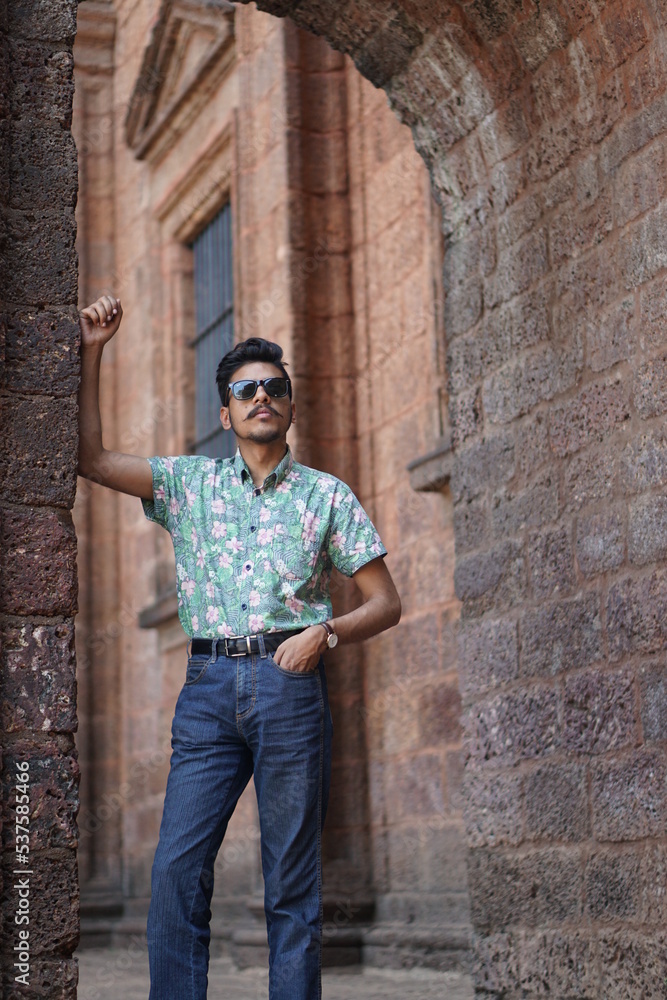man posing infront of old goa chruch man posing infront of old goa chruch