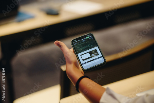 Show your phone in conference hall at business event. Audience at the conference hall. 