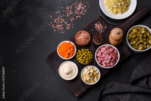 Delicious fresh Olivier salad with sausage, egg, cucumber, green peas, carrots and mayonnaise