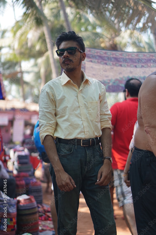 young man posing in market ear beach