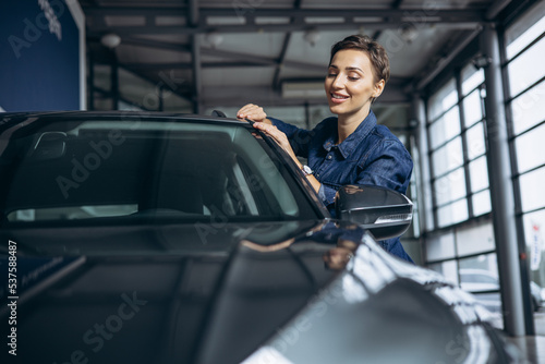 Wallpaper Mural Young woman choosing a car at car showroom Torontodigital.ca