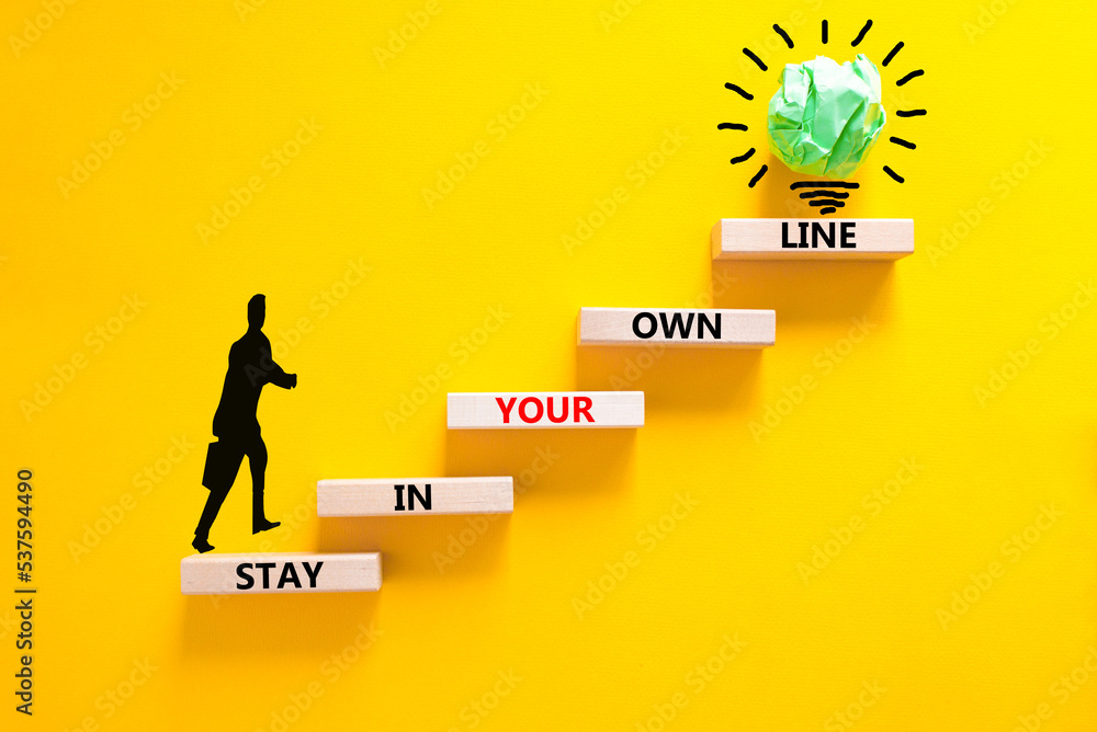 Stay in your own line symbol. Concept words Stay in your own line on wooden blocks. Businessman icon. Beautiful yellow table yellow background. Business and stay in your own line concept. Copy space.