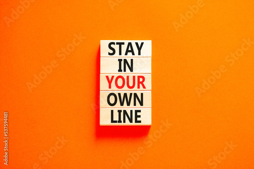 Stay in your own line symbol. Concept words Stay in your own line on wooden blocks. Beautiful orange table orange background. Business and stay in your own line concept. Copy space.