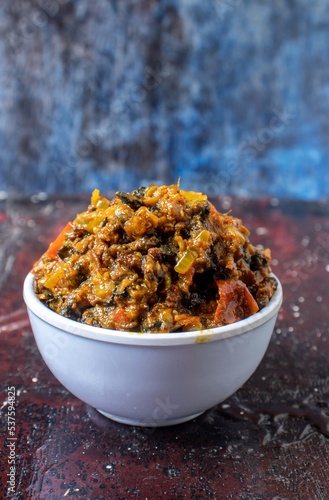 Closeup of Snail Gravy or Curry in a Bowl Isolated on Bluish Background in Vertical Orientation