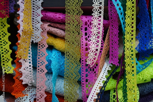 Valokuva Lace ribbons in varied colors and patterns displayed for sale at haberdashery sh