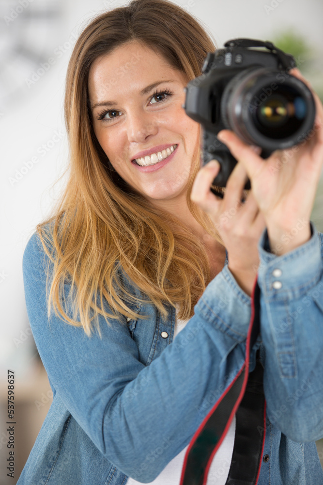 beautiful long-haired photographer holding a camera