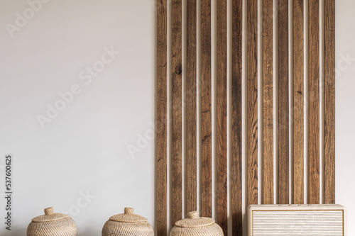 Modern Japandi appartment interior design in earth tones, natural textures. Solid oak wood wall decoration. Japandi concept