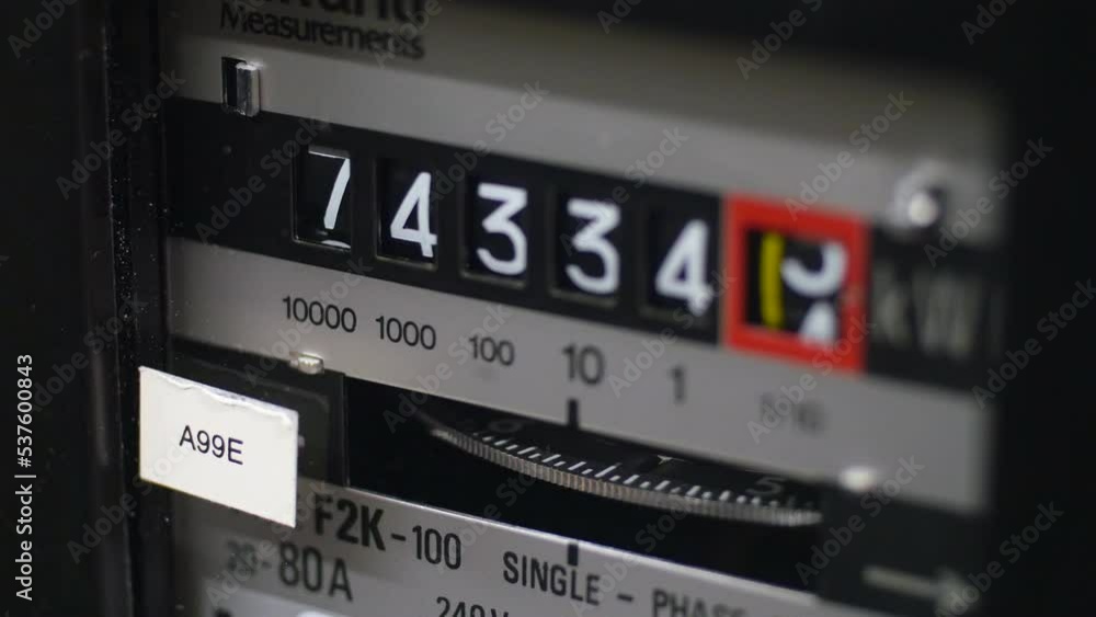 A close-up of an electric meter and digits. A turning dial showing energy in use. Concept for cost of living crisis, fuel bills, inflation and high bills. Static shot. A close-up of an electric meter and digits. A turning dial showing energy in use. Concept for cost of living crisis, fuel bills, inflation and high bills. Static shot.