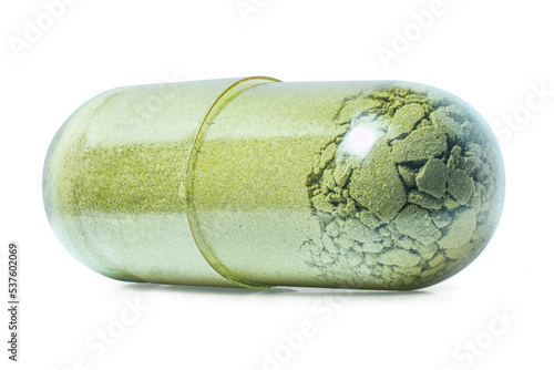 Matcha Supplement Pill Capsule Isolated on White Background with Shadow Extreme Macro photo