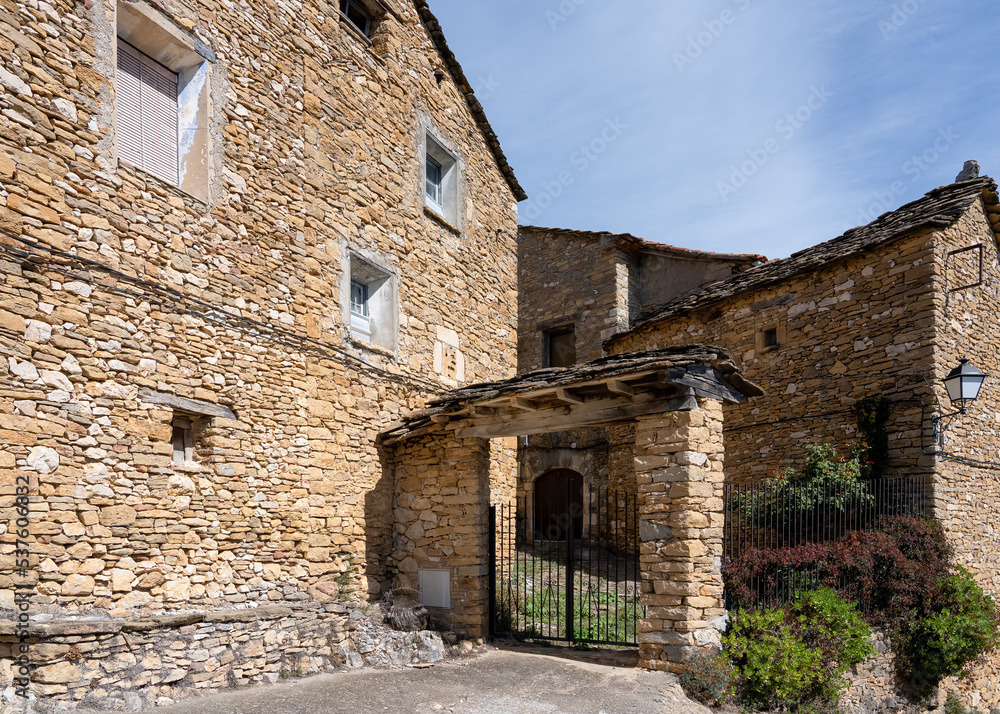 old Spanish beige stone village property in summer sunshine