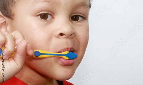 little boy brushing his teeth with an electric tooth brush stock image with white background stock photo