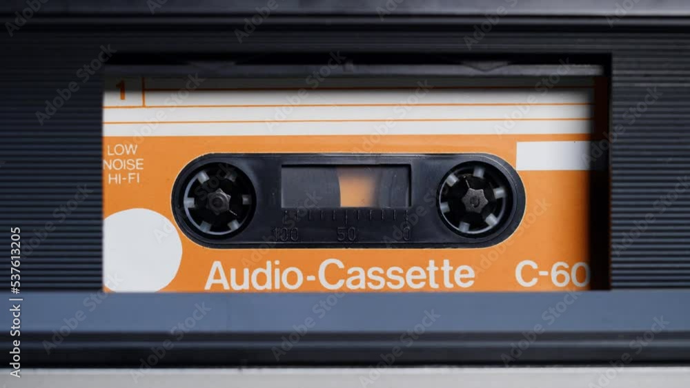 Retro radio tape recorder, audio cassette close-up. Listening to music, old radio boombox player, searching channel. Retro radio tape recorder, audio cassette close-up. Listening to music, old radio boombox player, searching channel.