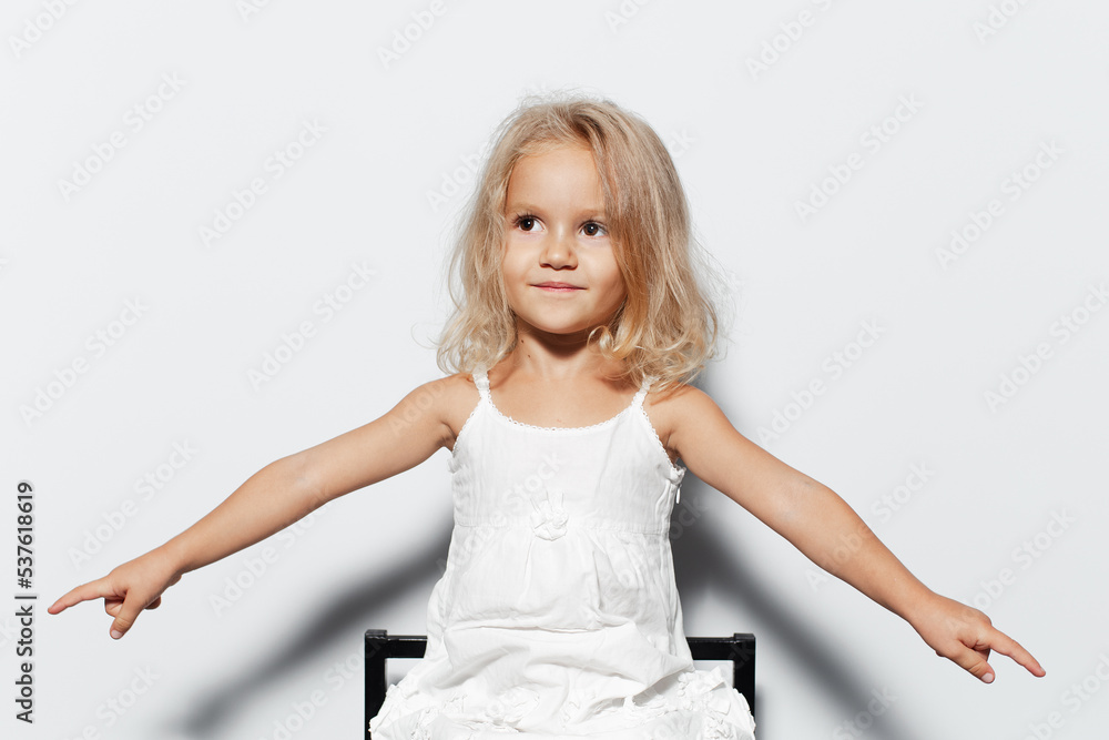 Studio portrait of smiling child girl with blonde hair on white background. Studio portrait of smiling child girl with blonde hair on white background.