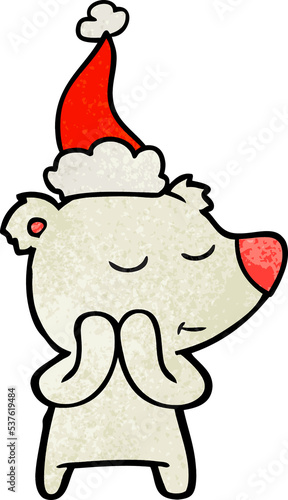 happy hand drawn textured cartoon of a polar bear wearing santa hat © lineartestpilot