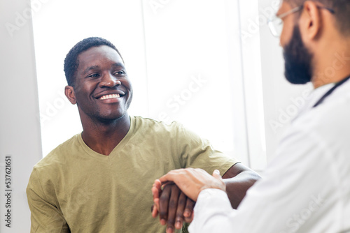 doctor and male patient talking at office consultation for further treatment