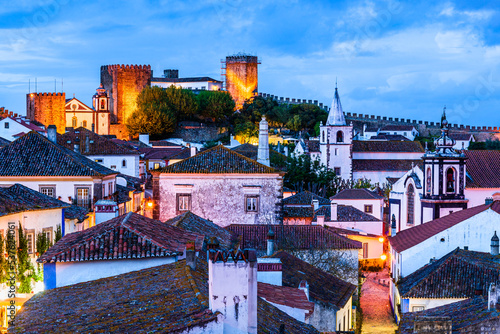 Canvas-taulu Evening skyline of Obidos village in Portugal; Twilight cityscape of medieval vi