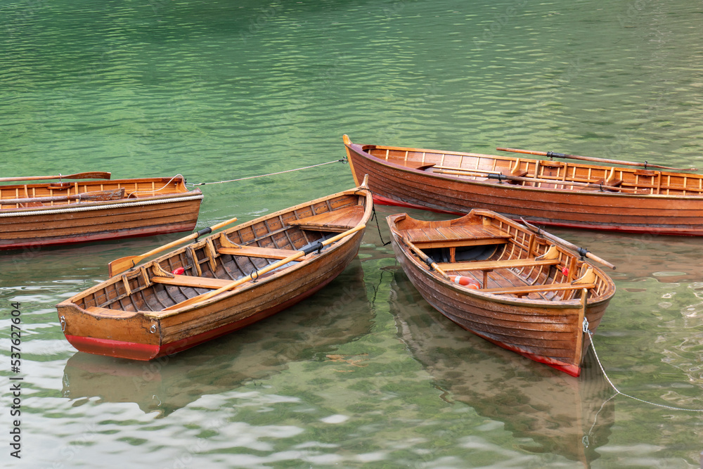 Wooden boats on the lake Braies. Tourist, famous place in the Dolomites. Italy. Beautiful nature. Beautiful places. A means of transportation. Logo di Braies.Pragser Wildersee Wooden boats on the lake Braies. Tourist, famous place in the Dolomites. Italy. Beautiful nature. Beautiful places. A means of transportation. Logo di Braies.Pragser Wildersee