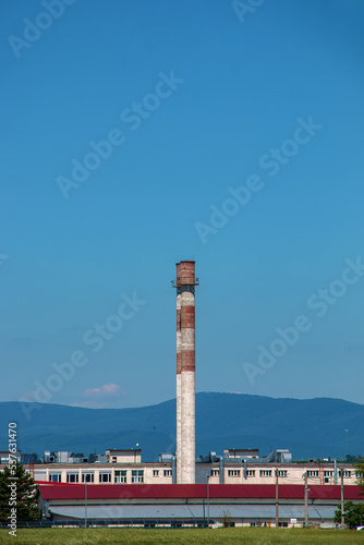 View en exhaust pipe of an industrial plant against the blue sky. The company is not working. There are no exhaust gases. Energy crisis. © Nataliia
