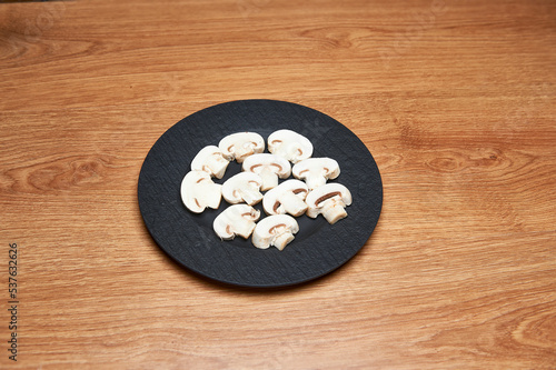 sliced mushrooms on black plate