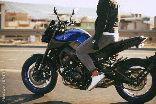 Man riding a supersport motorcycle with no hands. photo