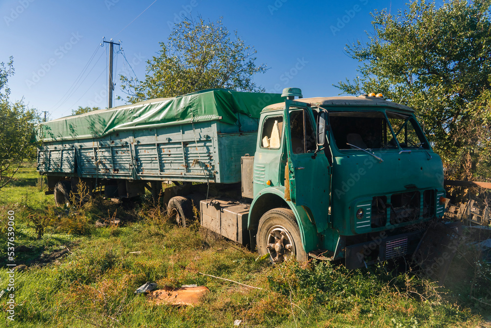War in Ukraine. 2022 russian invasion of Ukraine. Countryside. Damaged truck after shelling. Terror of the civilian population. War crime War in Ukraine. 2022 russian invasion of Ukraine. Countryside. Damaged truck after shelling. Terror of the civilian population. War crime