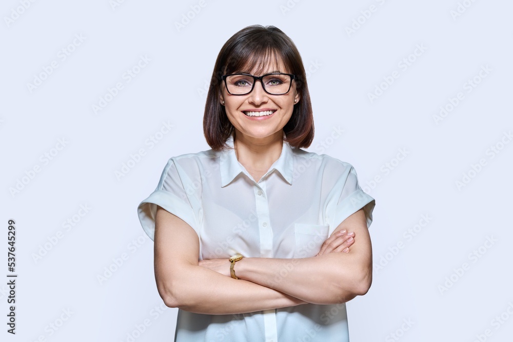 Attractive middle aged woman looking at camera on white background Attractive middle aged woman looking at camera on white background
