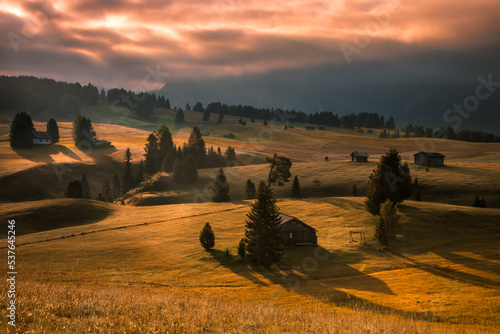 Cloudy sunrise on Seiser Alm meadow in Dolomites