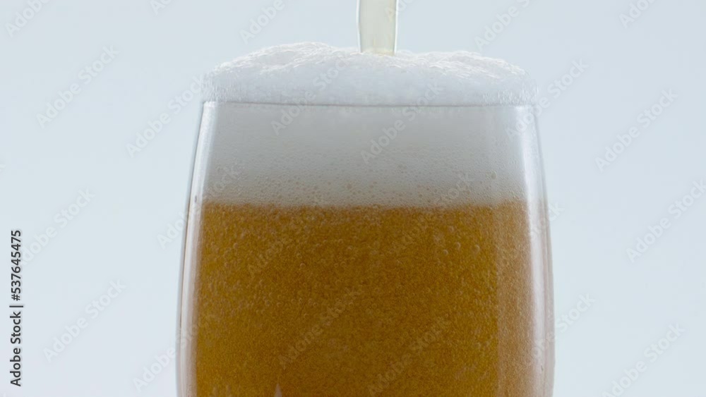 Froth beer pouring bubbling inside glass in super slow motion close up. Froth beer pouring bubbling inside glass in super slow motion close up.