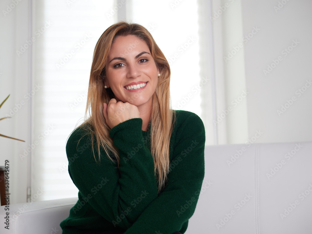 Carefree woman relaxing sitting on a sofa at home Carefree woman relaxing sitting on a sofa at home