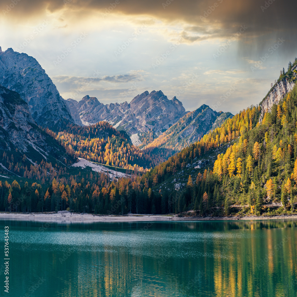 Fototapeta premium Autumn peaceful alpine lake Braies or Pragser Wildsee. Fanes-Sennes-Prags national park, South Tyrol, Dolomites Alps, Italy, Europe. Picturesque traveling, seasonal and nature beauty concept scene.