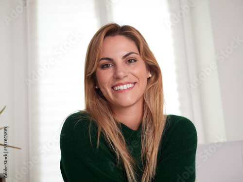 Carefree woman relaxing sitting on a sofa at home