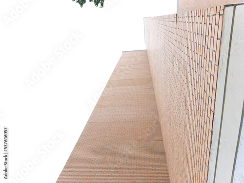The wall of a tall red brick building. Picture from below