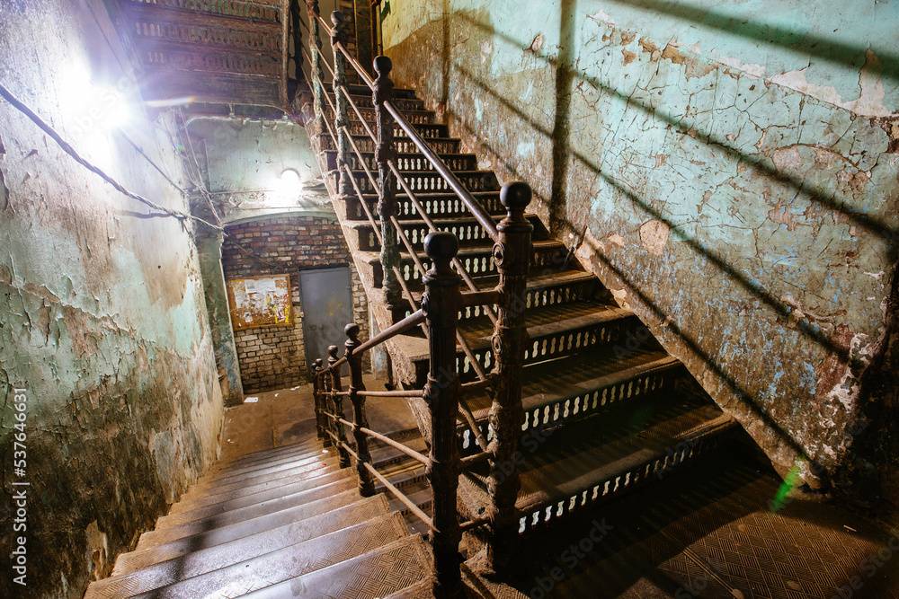 Old forged iron staircase in shabby historical building Old forged iron staircase in shabby historical building