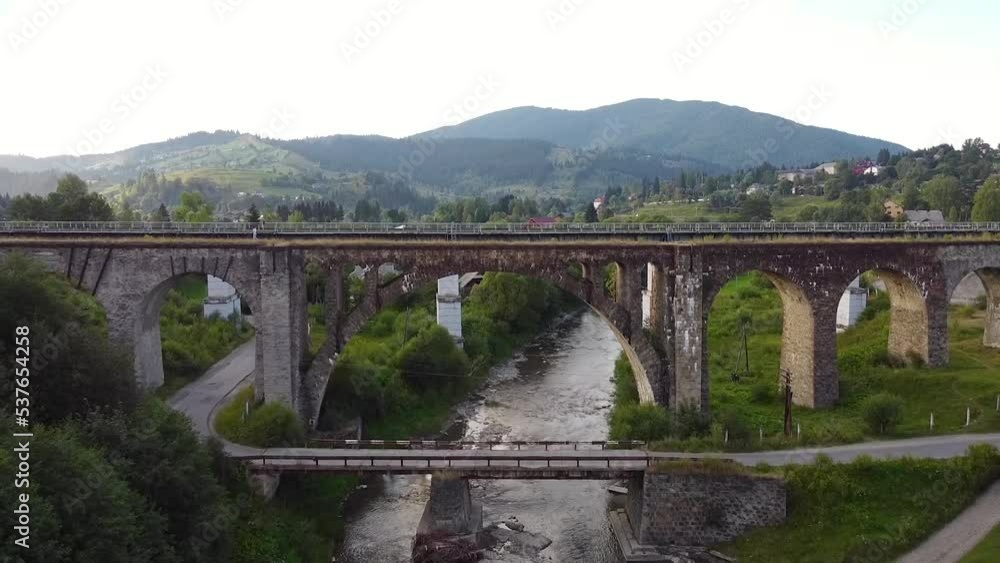Bridge over the river in the mountains shot by drone. Drone filmed video of viaduct