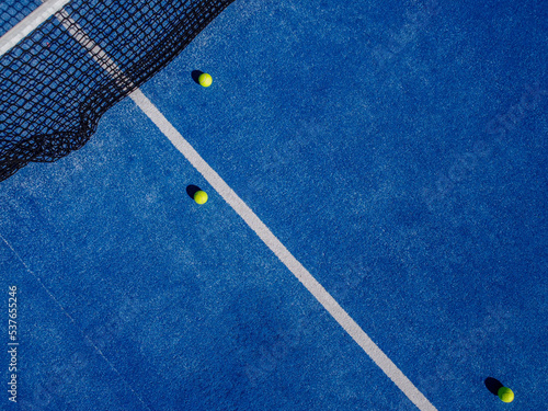 Obraz na plátně Drone aerial view of three balls in a blue paddle tennis court