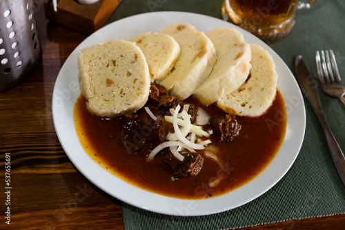 Traditional old Bohemian dumplings served with beef goulash. Dish of Czech cuisine..