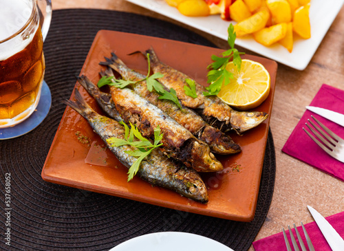 Fried sardines with lemon and parsley clodeup