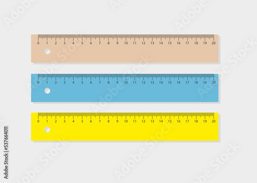Three realistic rulers in blue, brown and yellow colors