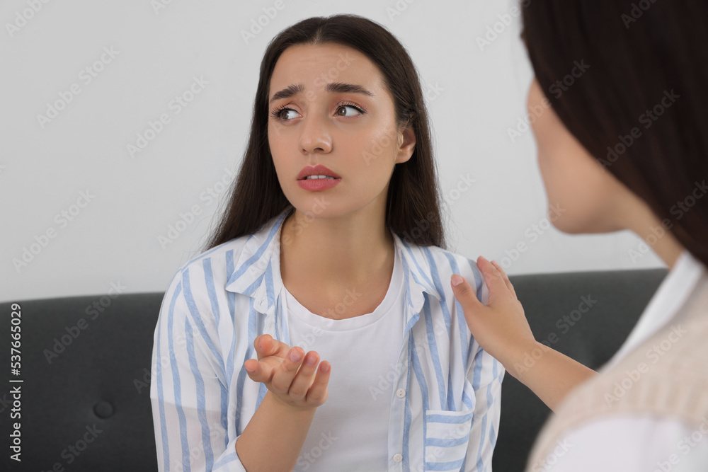 Professional psychologist working with young woman in office Professional psychologist working with young woman in office