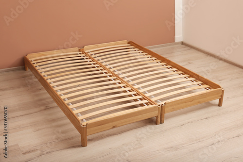 Wooden bed frame on floor in room