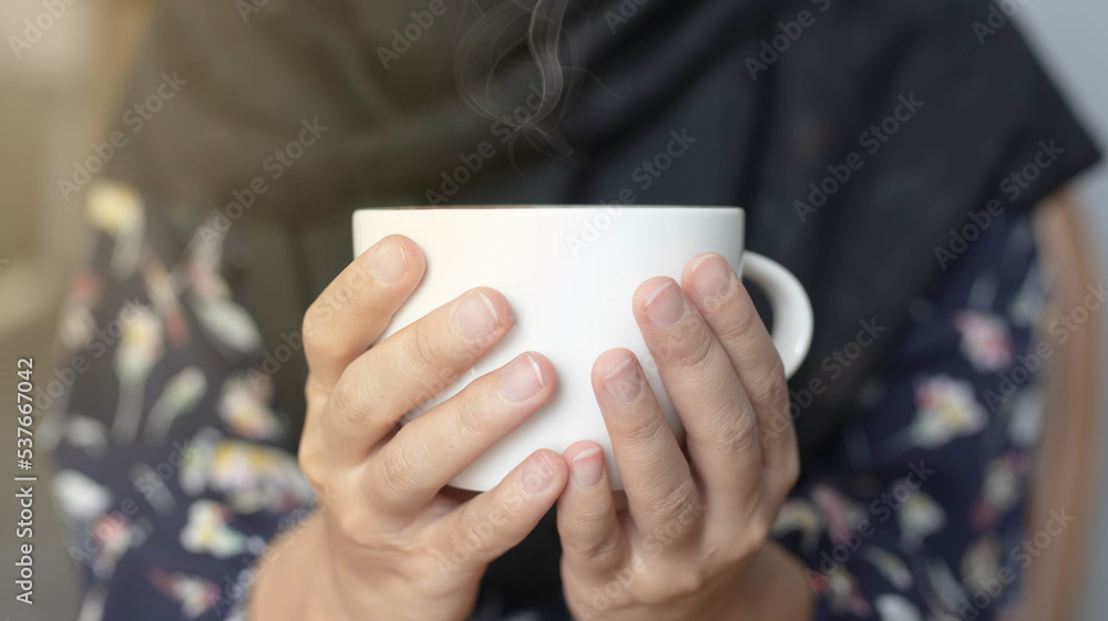 girl drinking and enjoying coffee during working in cafe. Close-up photo of Asian woman smelling and drinking hot coffee with good vibes in a cafe. girl drinking and enjoying coffee during working in cafe. Close-up photo of Asian woman smelling and drinking hot coffee with good vibes in a cafe.