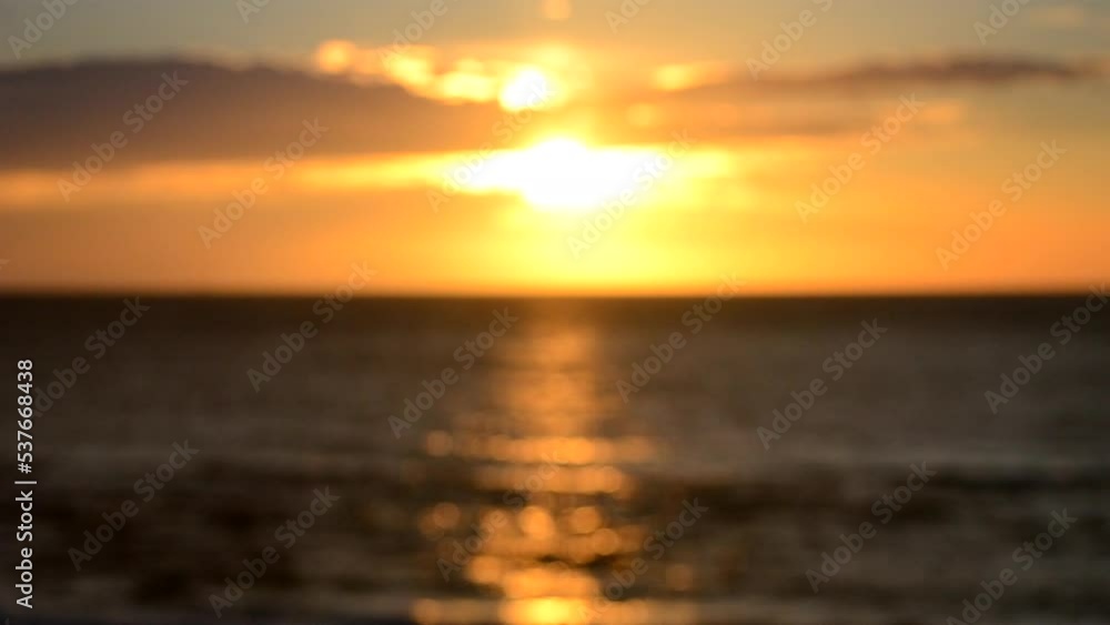 Blurred background. Sun shining in sky with clouds during sunset dawn. Sunrise dawning sundown. Sunny path, sunny walkway on surface of sea waves. Sunlight. Sea landscape. Natural blurry bokeh texture Blurred background. Sun shining in sky with clouds during sunset dawn. Sunrise dawning sundown. Sunny path, sunny walkway on surface of sea waves. Sunlight. Sea landscape. Natural blurry bokeh texture